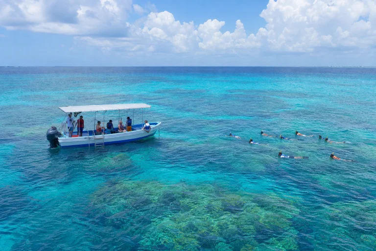 Guided boat excursion over blue water near Colombia Reef in Cozumel