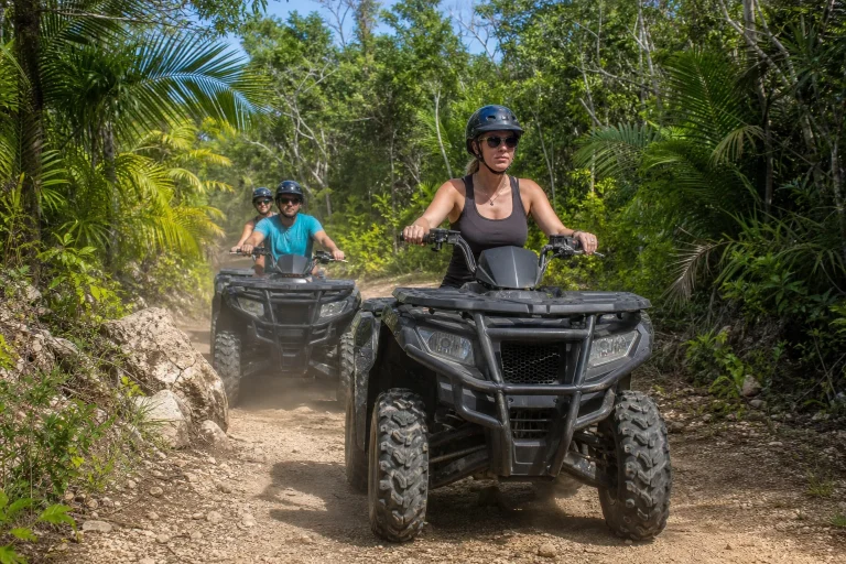 Travelers riding ATVs on a guided tropical trail in Cozumel
