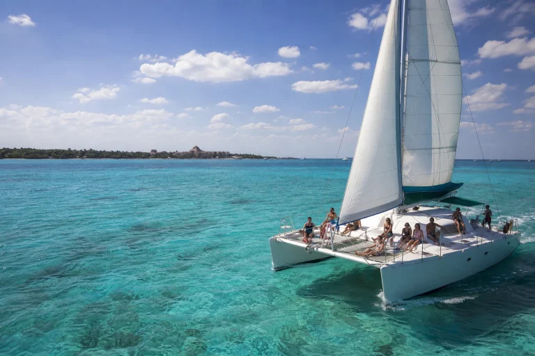 Catamaran sailing across turquoise water near Cozumel