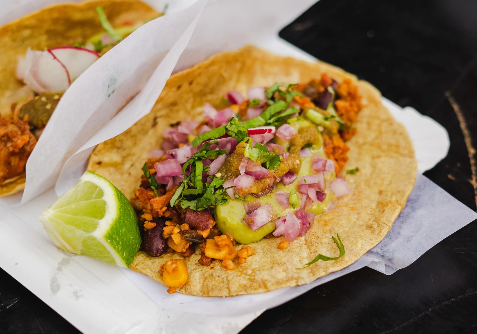 Plate of Mexican tacos and ceviche on a wooden table