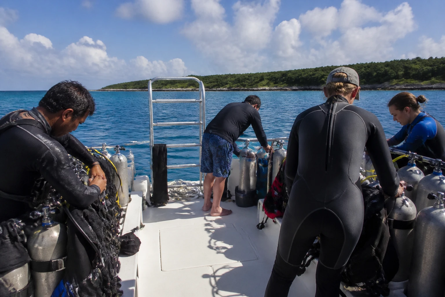 Divers preparing equipment on a Cozumel dive boat